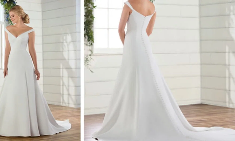 Schlichtes Brautkleid mit schulterfreiem Ausschnitt und eleganter Schleppe, perfekt für einen klassischen Hochzeitslook. Die Rückansicht zeigt eine durchgehende Knopfleiste.
