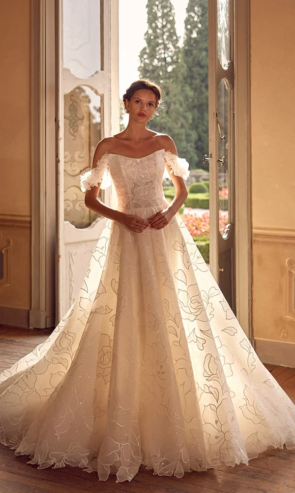 Traumhaftes Hochzeitskleid mit floral besticktem Tüll und weicher Silhouette, perfekt für romantische Sommerhochzeiten.