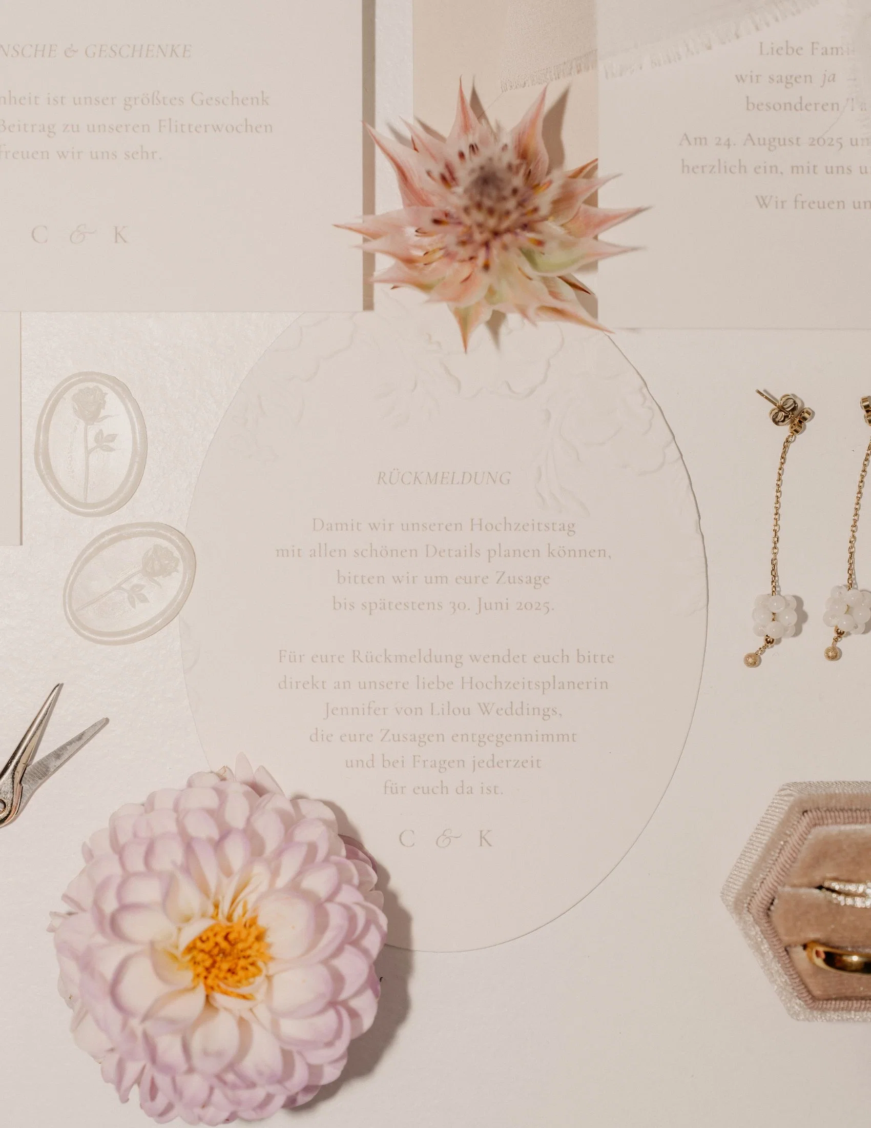 Elegante Hochzeits-Papeterie mit geprägter Karte und Platzschild „Madleen“, dekoriert mit Trockenblumen und Siegelstempel in zarten Rosé- und Cremefarben.