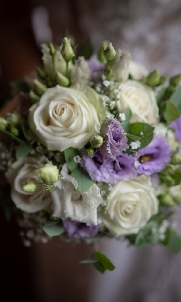 Violette-weisser Blumenstauss, passend zur Deko der Hochzeit