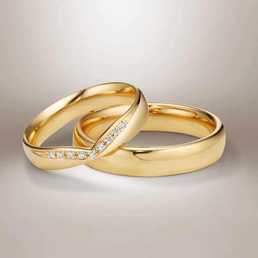 Polierte Trauringe aus Gelbgold mit V-förmiger Diamantlinie – zeitlose Eheringe mit modernem Akzent.